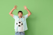 © Pixel-Shot - Happy young man with soccer ball and money on green background. Sports bet concept
