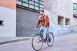 © Oscar - Young man riding bicycle for urban delivery service