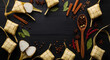 © Wilanda - Festive Eid Al-Fitr Food Concept with Authentic Ketupat and Wooden Spoon on Dark Wood Background for Greeting Card Template