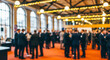 © Rahman - Blurred blurred image of a large group of business professionals networking at a conference event in a spacious hall with warm lighting and elegant decor