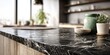 © Ocang - A dark, veined countertop with decorative jars and a potted plant