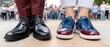 © pvl0707 - Close view of man in black leather shoes standing next to woman in blue sneakers on sidewalk for game concept at crowded event