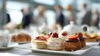 © Ubix - Afternoon Tea Delight: A tantalizing array of delicate pastries and cakes adorn a pristine table set for an elegant afternoon tea, inviting indulgence and leisurely enjoyment.