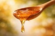 © justjupiter - A wooden spoon dripping with golden honey against a soft, blurred background, highlighting the fluidity and natural sweetness of the liquid.