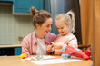 © Maria Vitkovska - Mother and daughter enjoying creative crafting activity together at home