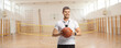 © Ljupco Smokovski - Basketball coach holding a ball at a gymnasium