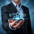 © Roushon - A businessman's hand holding a smartphone displays five glowing stars, symbolizing an excellent customer rating and positive feedback.