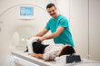 © Zoran Jesic - Radiographer preparing patient for mri knee scan