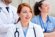 © StockMe - Medical team standing outdoors, female doctor looking away and smiling, healthcare professionals collaborating