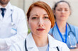 © StockMe - Confident woman doctor with a serious expression leading a hospital medical team, providing healthcare and professional medical services