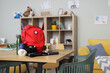 © Pixel-Shot - Emergency backpack with necessities on table in classroom interior