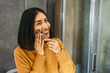 © Alberto - Woman using jade roller on face practicing beauty and wellness self care