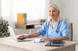 © Pixel-Shot - Female doctor working with laptop at table in clinic
