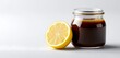 © Azib - A jar filled with rich teriyaki sauce and zesty lemon vinaigrette, placed against a clean white background
