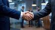 © Oye - Business professionals finalize a successful partnership agreement with a firm handshake in a modern corporate office setting
