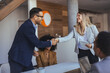 © Dragana Gordic - Professional Man And Woman Shake Hands In Modern Office During Meeting And Collaboration