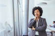 © Dragana Gordic - Confident Business Woman Posing by Large Window in a Modern Office Environment