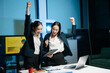 © Nuttapong punna - Two businesswomen celebrating success after achieving goals at office desk. Teamwork, motivation, leadership, startup growth and modern corporate workplace.