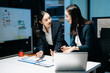 © Nuttapong punna - Two professional businesswomen analyzing reports and planning strategy at office desk. Teamwork, collaboration, management, consulting and modern corporate workplace.
