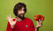 © kues1 - young adult bearded man with a red pepper