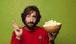 © kues1 - young adult bearded man. popcorns and movie concept