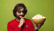 © kues1 - young adult bearded man. popcorns and movie concept