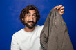 © kues1 - young adult bearded man holding a dirty short pants