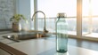 © backup_studio - Glass water bottle. Refreshing beverage concept in modern kitchen with sink and sunny window. Healthy hydration.
