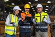 © BJ Day Stock - Professional asian engineer and technician wearing safety helmet analyzing meeting with tablet in factory warehouse. Confident factory workers group inspection industry factory. Teamwork concept.