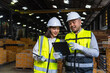 © BJ Day Stock - Professional asian engineer and technician wearing safety helmet analyzing meeting with tablet in factory warehouse. Confident factory workers group inspection industry factory. Teamwork concept.