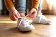 © Godam - Child Tying Shoelaces in Bright Room Before Leaving for Outdoor Activity