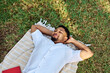 © Lumos sp - Young man student businessman enjoys sunny day while reading a book in park, highlighting his joy and connection to the world around him