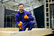 © Petro - Male worker cutting wooden bars for modular buildings