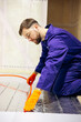 © Petro - Worker installing warm floor in modular house
