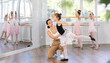 © JackF - At ballet lesson, mentor corrects girls arm and leg, teaches correct dynamics and execution of movements. Makes remarks during lesson