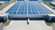 © SYATRI RAWU - Modern industrial warehouse with a vast rooftop solar panel system, demonstrating commitment to green energy and efficient logistics