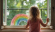 © andyaziz6 - Little girl with wavy, blonde hair drawing colorful rainbow on a glass window using vibrant markers, enjoying creative art activity indoors