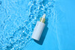 © Tuan  Nguyen  - Small pump bottle floating on clear water with light reflections. Bright, modern scene designed for cosmetic promotion and clean branding layouts