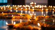 © IMAGINIAC - Golden Marigold Flower Garland and Lit Diyas on Shiny Floor