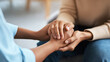 © Bonsales - Close up of two people holding hands, providing comfort and emotional support during a moment of empathy and care