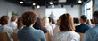 © perfectlab - Audience attending a seminar or conference in a modern meeting room with a speaker presenting in front of a projection screen