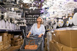 © Ivan Traimak - Woman shopping for lighting fixtures in a well-stocked home improvement store during the day