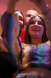 © Nikola Spasenoski - Group of young adults celebrating with smiles and colorful attire during an evening gathering