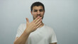 © Krakenimages.com - Young hispanic man hand covering mouth with puzzled frown and furrowed brow in pale blue studio; disgust.
