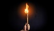 © Joseph - a hand holding a burning torch in the dark suitable for dramatic or mysterious themes