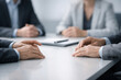 © Rohan Katwe - Professional Business Meeting. group of professionals sit around clean conference table, hands resting in front, signaling focused and collaborative business discussion. planning and decisive teamwork