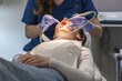 © Nataliya - The dentist cleans the patient's mouth.