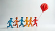 © miss irine - Colorful origami people figures link hands forming a chain, running together, led by one holding a red balloon. Teamwork, unity, and shared goals are symbolized.