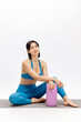 © wedmoments.stock - Fit young woman posing for fitness photo on mat with foam roller. Wellness, body care and fitness concept.