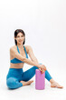 © wedmoments.stock - Woman posing on fitness mat with foam roller. Fitness, wellness and active lifestyle concept.
